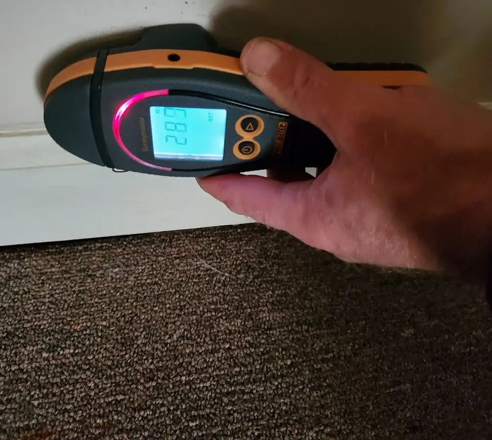 Moisture detection at baseboard during Storm Damage Restoration in Dalhart